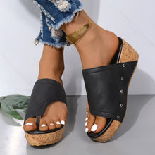 Model wearing PU Leather Wedge Sandals in black with legs crossed 
