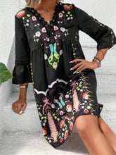 Model seated at a modern resort stairs in Black Qelorian Lace Mini Dress, styled with bronze jewelry and handbag.