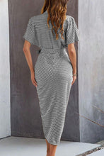 Back view of black Qivany midi shirt dress showing structured collar and textured color contrast design.