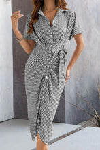 Front view of black Qivany midi shirt dress with button-up front, waist tie, and textured zigzag pattern.