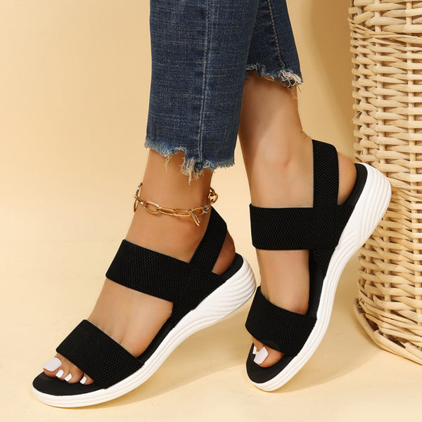 Model wearing Rubber Open Toe Low Heel Sandals in black styled with gold anklet