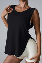 Woman modeling the front of the black Slit Round Neck Active Tank top.