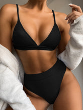 Close-up front view of black spaghetti strap ribbed bikini set with adjustable straps and ribbed texture detail