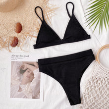 Front flat lay of black spaghetti strap ribbed bikini set displayed on hanger with adjustable straps