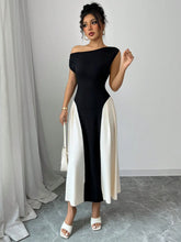 Woman attending a chic rooftop cocktail event in Black TéMiraj Lumière Contrast Single Shoulder Midi Dress paired with gold jewelry and a white shoulder bag.