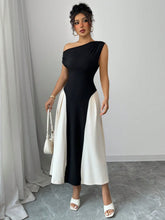 Model styling Black TéMiraj Lumière Contrast Single Shoulder Midi Dress with gold hoop earrings, gold bangle, white shoulder bag, and white square open-toe heels.