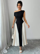 Model stepping into an upscale evening party in Black TéMiraj Lumière Contrast Single Shoulder Midi Dress styled with gold accessories and sleek heels.