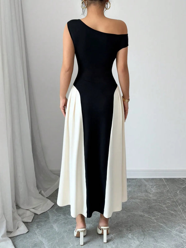 Back view of model in Black TéMiraj Lumière Contrast Single Shoulder Midi Dress highlighting flattering fit and sleek contrast paneling.