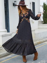 Model wearing black Veyonna dress at a sunlit park picnic with a woven handbag and soft waves.