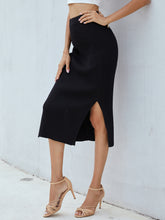 Side view of black Zynoria Ribbed Side Slit Midi Skirt showcasing side slit detail