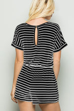 Back view of model wearing striped romper showing back button closure, soft breathable fabric, and blackivory vertical stripe design.