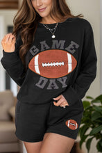 a model wearing the black Blitzelle™ GAME DAY Football Shorts Set paired with jewelry 