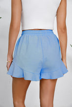Rear shot of blue shorts, highlighting relaxed fit and airy movement.