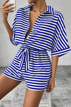 Side profile of LineaVerra™ Blue Romper showing striped fabric and waist tie.
