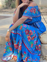 Model in blue Isadorae Maxi Dress styled with wedges for dinner reservation.