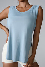 Model wearing blue slit round neck active tank with joggers outdoors