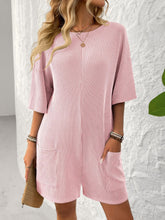 Model in blush pink Breezy Bold Romper at an outdoor market.