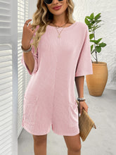 Model in blush pink Breezy Bold Romper at a day party.