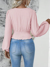 Back view illustrating the blush pink Balloonique blouse's fit and design.