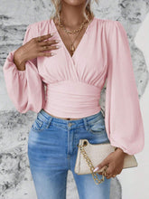 Model styled in blush pink Balloonique™ Blouse with accessories for a complete look.