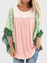 Model wearing BlossomEase Blouse in blush pink with floral sleeves and relaxed fit.