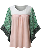 Front view of the BlossomEase Blouse in blush pink to show floral sleeves and ruffle trim.