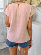 Back view displaying the blush pink CrochetCharm Top's back button closure and overall design.