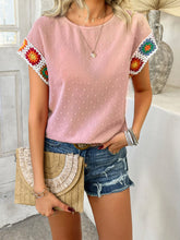 Model styled in blush pink CrochetCharm Top with casual shorts, heels, a brown straw purse, and accessories for a complete look.