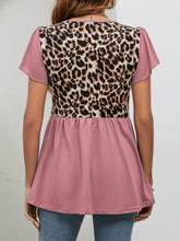 Back view of dusty pink leopard babydoll blouse featuring flutter sleeves and a softly draped back with a relaxed, feminine shape.
