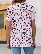 Back view of blush pink leopard print round neck tee featuring short sleeves and a lightweight, casual fit.