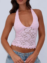 Model wearing blush pink Seraphinelli Lace Halter Blouse with backless silhouette and floral lace.