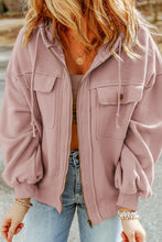 Side profile of model in blush pink Nivora™ DriftZip Hoodie showing drawstring hood and relaxed, flattering fit.