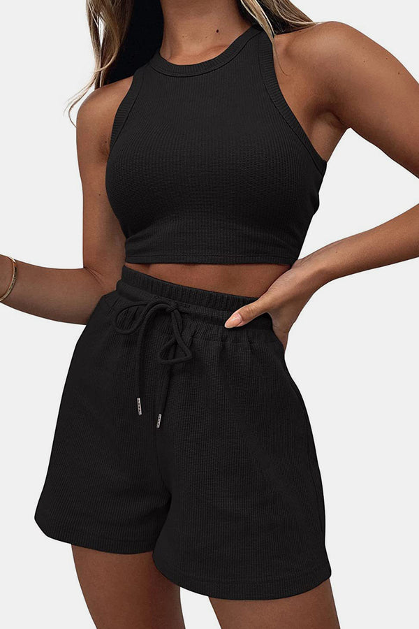 Close-up front view of a model showcasing the black Boundary Babe Round Neck Top and Drawstring Shorts Set paired with a gold bracelet.