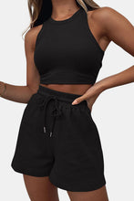 Close-up front view of a model showcasing the black Boundary Babe Round Neck Top and Drawstring Shorts Set paired with a gold bracelet.