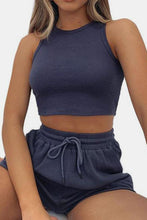 Model in dark blue Boundary Babe set barefeet doing yoga at a city studio.