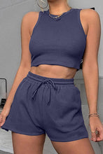 Front view of model in dark blue Boundary Babe Round Neck Top and Drawstring Shorts Set running errands.