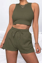 a model showcasing the dark green Round Neck Top and Drawstring Shorts Set paired with jewelry