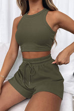 Model in dark green Boundary Babe set with white canvas sneakers for relaxed outdoor lunches.