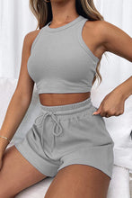 Woman conversing with a business partner wearing the Boundary Babe light gray Round Neck Top and Drawstring Shorts Set styled with accessories and loafers.