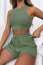 Model wearing the Boundary Babe matcha green Round Neck Top and Drawstring Shorts Set paired with a gold bracelet, and sneakers.