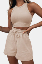 Detailed close-up of tan Boundary Babe ribb knit-textured fabric and waistband styled with accessories for casual chic look.