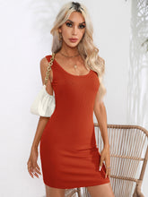 Model in the brick red Curvalicious Allure Bodycon Mini Dress styled for a night out with statement earrings and a clutch.