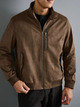 Brown Suavrix Men’s Luxe Suede Stand Collar Jacket side front angle model pose highlighting ribbed sleeve and zipped chest pocket.