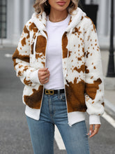 A model wearing the brown Western Patch design Fuzzy Drawstring Zip Hooded Jacket paired with a white tee, blue jeans, black and gold belt, and jewelry.