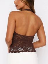 Backless brown lace design close-up highlighting soft floral motif and elegant cut.