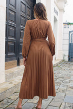 Rear view of Brown Zeleviane Pleated Maxi Dress, focusing on cascading pleats and tailored long sleeves.