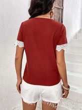 Back view of model wearing a burgundy Lace Detail V-Neck Short Sleeve T-Shirt, showing soft fabric and wavy lace trim on the short sleeves.
