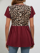 Rear shot of burgundy leopard print blouse with flutter sleeves and a flowing babydoll cut, highlighting the airy, flattering fit.