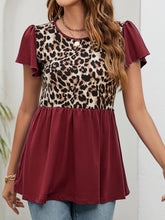 Burgundy leopard print babydoll blouse with round neck and flutter sleeves, styled with relaxed-fit jeans for a laid-back vibe.