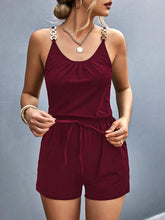 Model wearing Sunkiss Move Romper in burgundy, showcasing scoop neckline, adjustable buckle straps, and elastic drawstring waist.